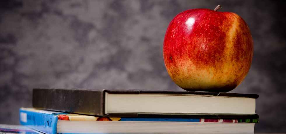 Time for school with books and an apple.